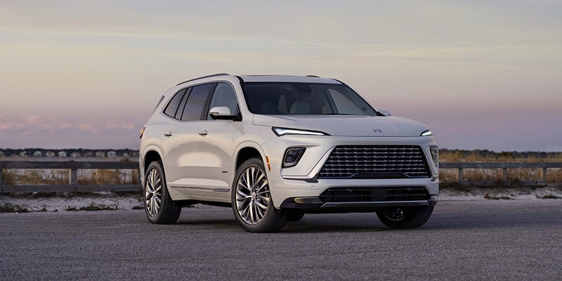 Side View of a 2025 White Buick Enclave Under an Evening Sky
